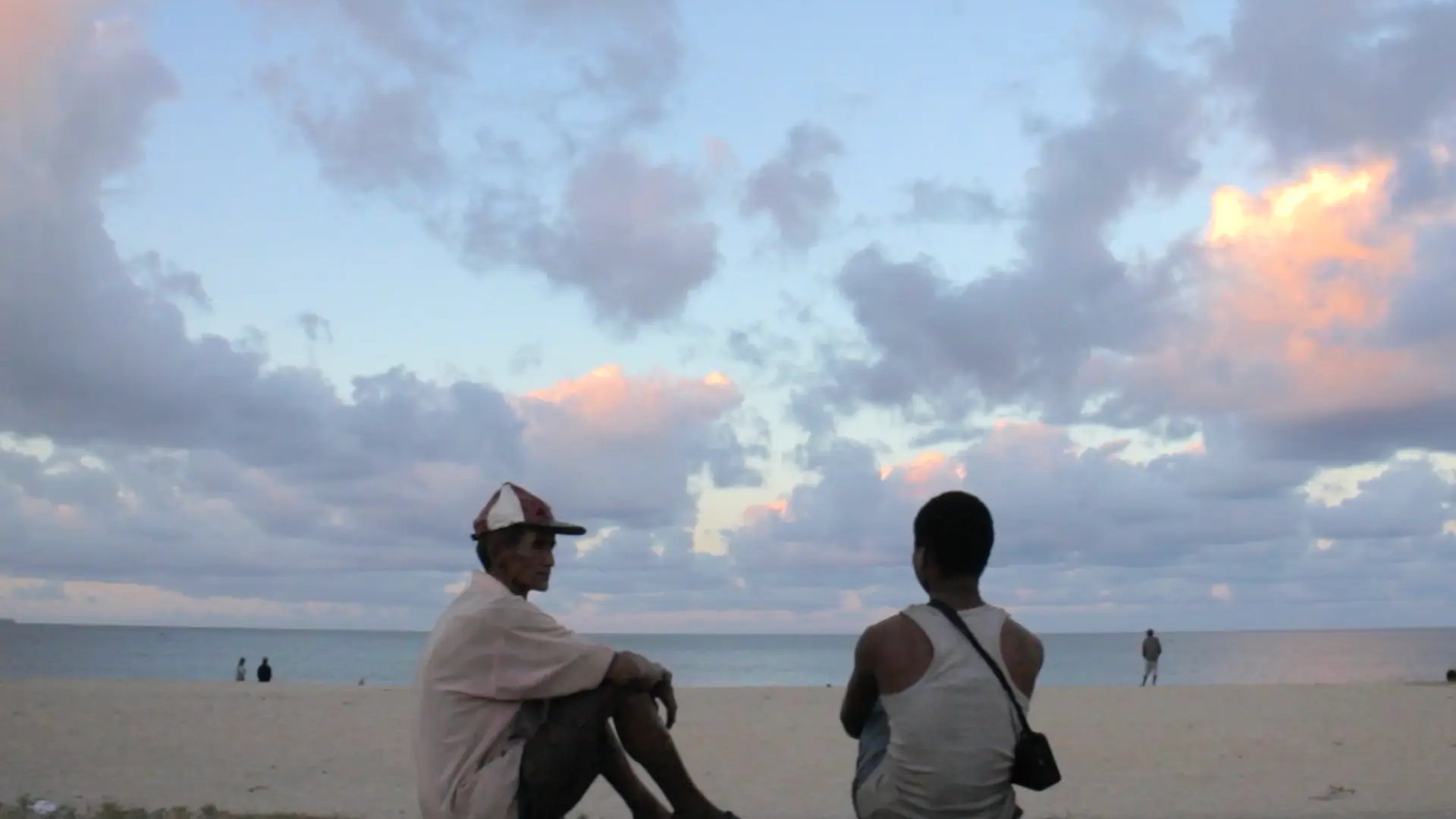 Deux hommes, de dos, sur la plage