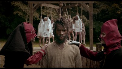 bourreaux et homme noir devant gibet cover